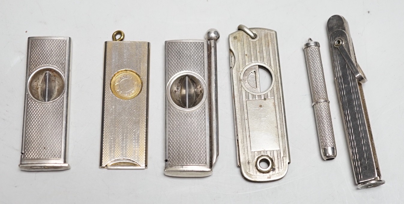 Two silver cigar cutters, a plated tamper and two other cutters / piercers